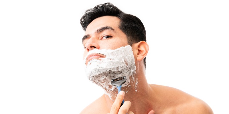 a man shaving his beard 