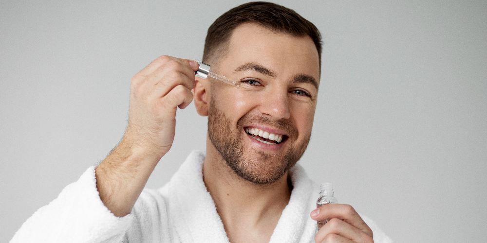 a man applying retinol on his face